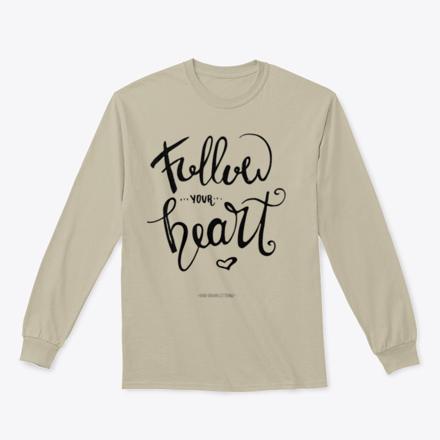 A stylish apparel featuring modern brush hand-drawn ink calligraphy saying 'Follow Your Heart' with a heart symbol, showcasing a blend of cotton and polyester.