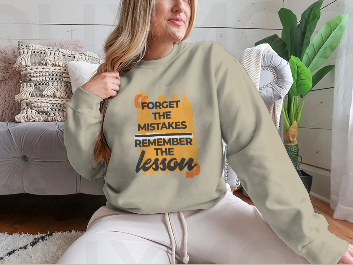 A stylish sweatshirt featuring the phrase 'Forget The Mistakes Remember', made from a comfortable cotton/polyester blend.