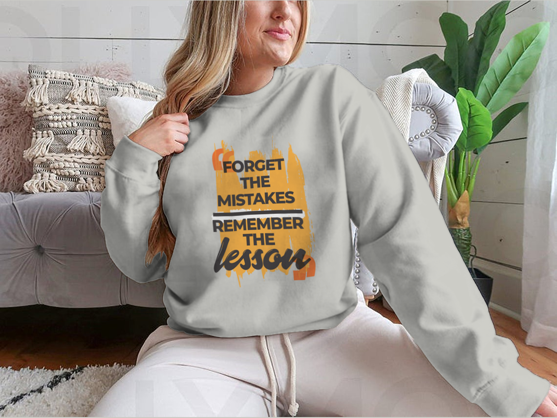 A stylish sweatshirt featuring the phrase 'Forget The Mistakes Remember', made from a comfortable cotton/polyester blend.