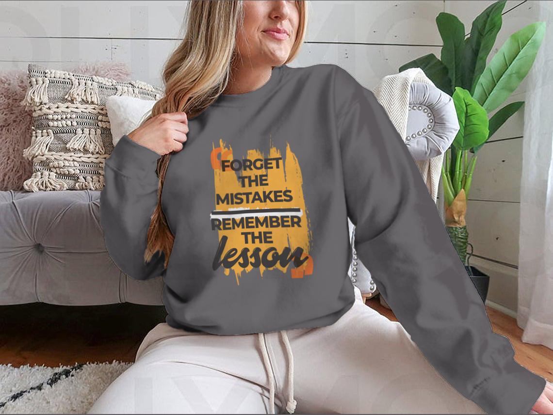 A stylish sweatshirt featuring the phrase 'Forget The Mistakes Remember', made from a comfortable cotton/polyester blend.