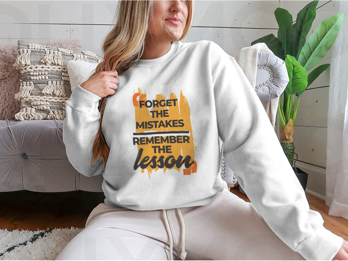 A stylish sweatshirt featuring the phrase 'Forget The Mistakes Remember', made from a comfortable cotton/polyester blend.