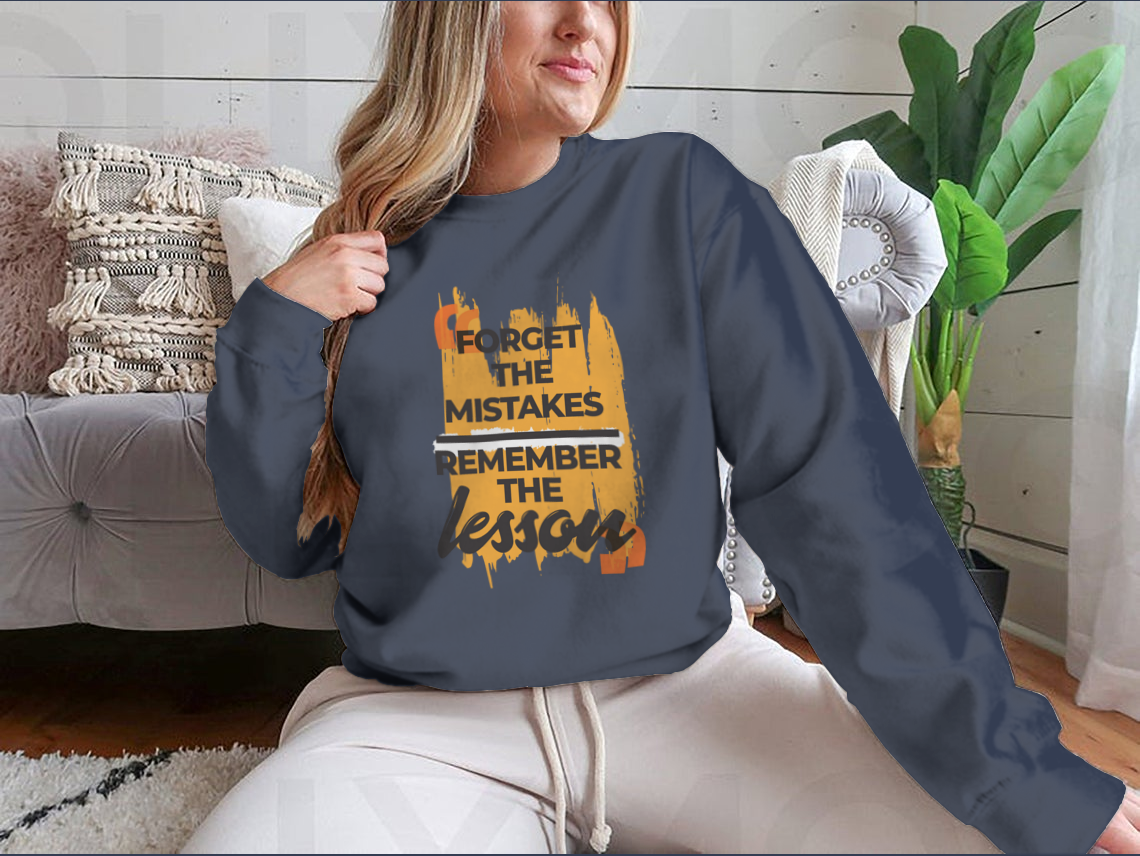 A stylish sweatshirt featuring the phrase 'Forget The Mistakes Remember', made from a comfortable cotton/polyester blend.