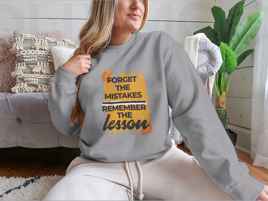A stylish sweatshirt featuring the phrase 'Forget The Mistakes Remember', made from a comfortable cotton/polyester blend.