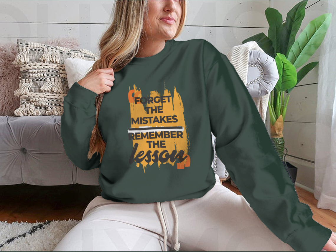 A stylish sweatshirt featuring the phrase 'Forget The Mistakes Remember', made from a comfortable cotton/polyester blend.