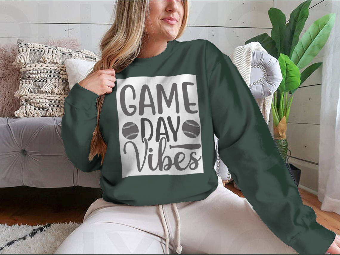 A stylish Game Day Vibes shirt featuring artistic lettering and an inspirational softball logo, perfect for fans and players.