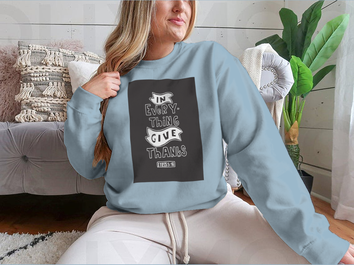 A stylish t-shirt featuring a hand-lettered 'Give Thanks' Bible quote in modern calligraphy, made from soft cotton fabric.