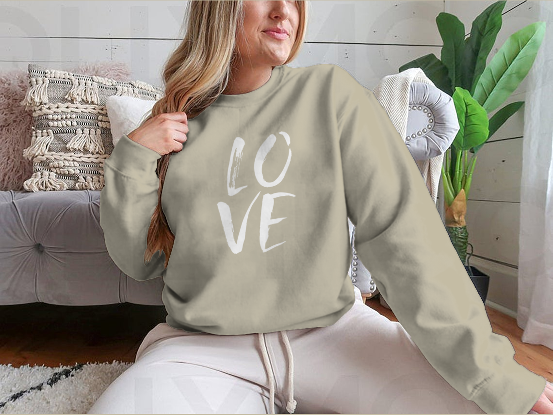 A cozy sweatshirt featuring hand lettered 'I Love' design in brushed ink, perfect for casual wear.