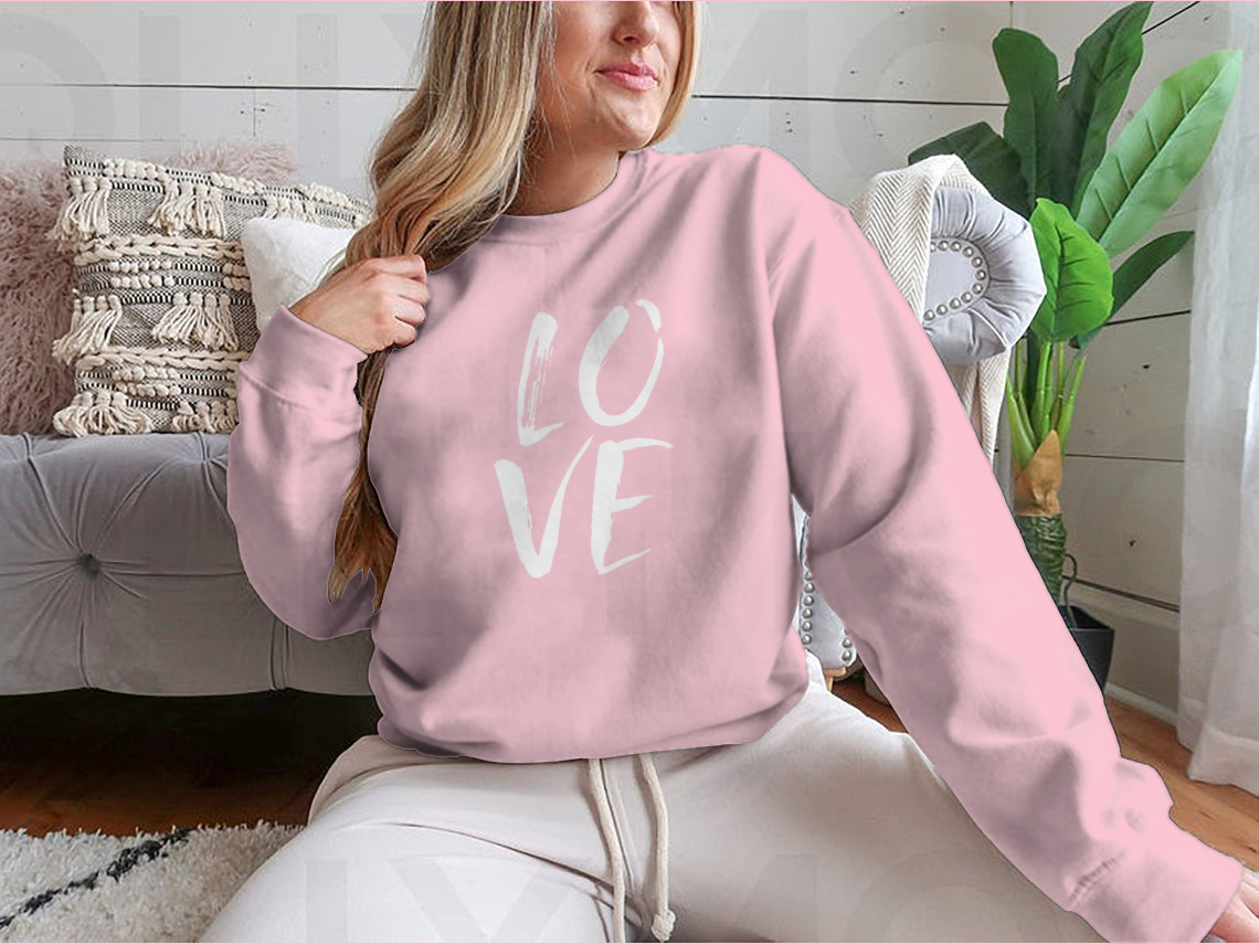 A cozy sweatshirt featuring hand lettered 'I Love' design in brushed ink, perfect for casual wear.