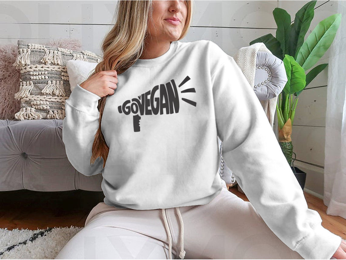 A stylish vegan slogan shirt featuring hand lettering text 'Govegan' in a loudspeaker silhouette, showcasing a commitment to eco-friendly living.