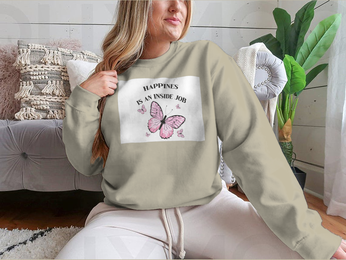 A stylish shirt featuring a pink butterflies design with the phrase 'Happiness Is An Inside Job', made from soft cotton fabric.