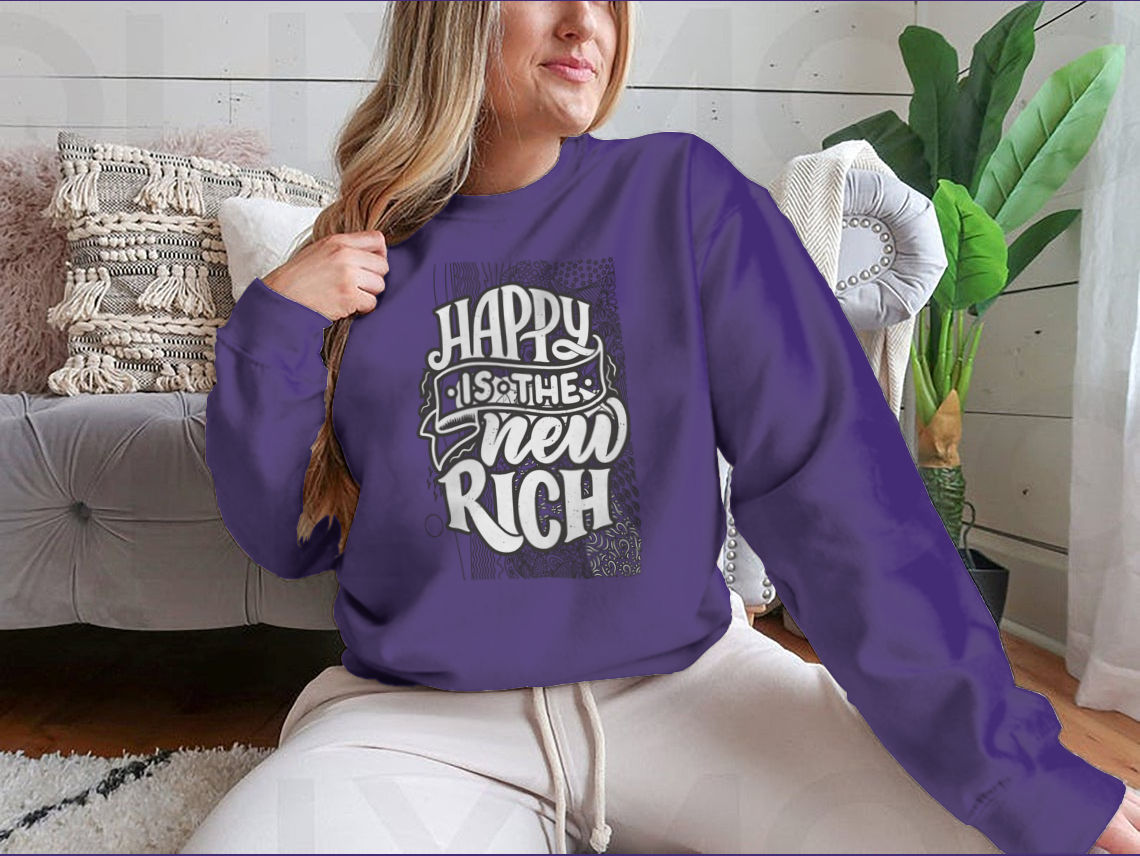 A cozy sweatshirt featuring the inspirational quote 'Happy Is The New Rich', made from a soft cotton-polyester blend, perfect for casual wear.
