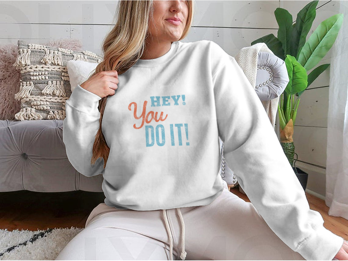 A cozy sweatshirt featuring the inspirational phrase 'Hey You Can Do It' in a stylish design, perfect for motivation and comfort.