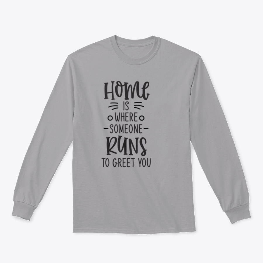 A cozy lettering design that reads 'Home Is Where Someone Runs To Greet You' on a soft cotton fabric, perfect for home or casual wear.