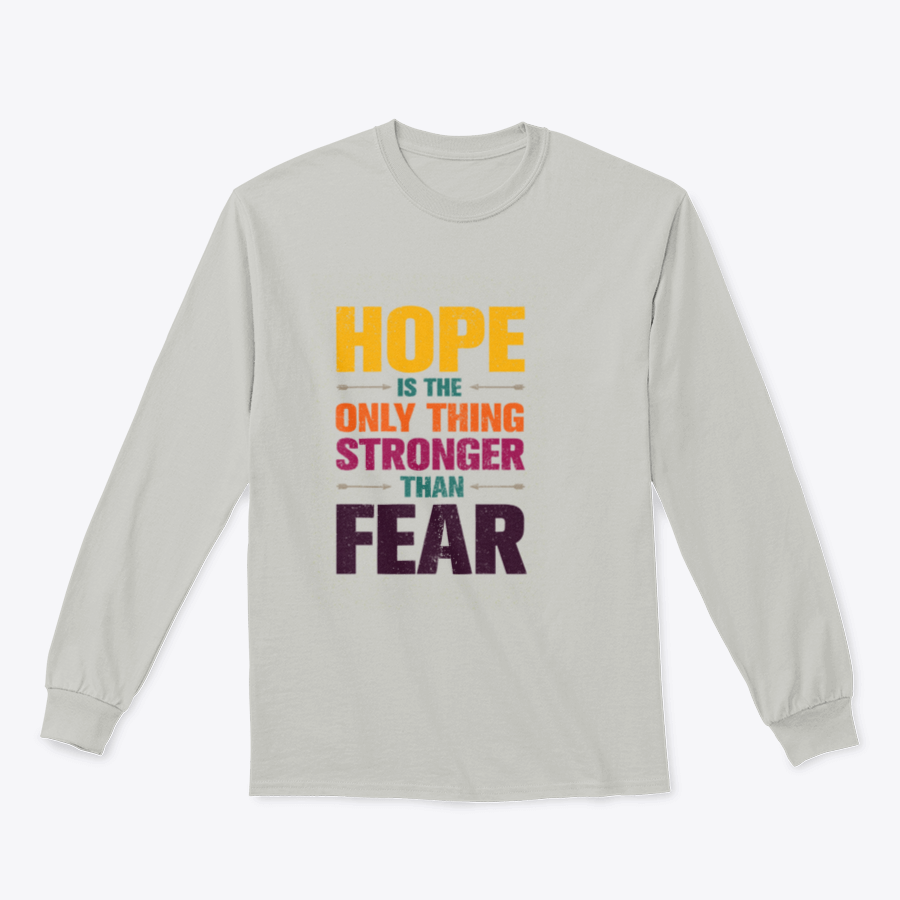 A stylish t-shirt featuring the inspirational quote 'Hope Is The Only Thing Stronger Than Fear' in a classic fit, made from a comfortable cotton-polyester blend.