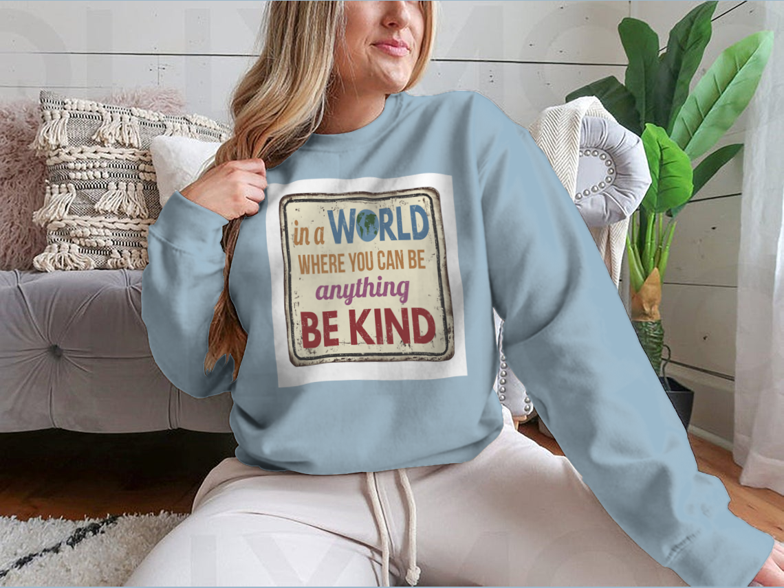 A stylish and comfortable t-shirt featuring the inspirational quote 'In A World Where You Can Be Anything Be Kind', made from a soft cotton/polyester blend.