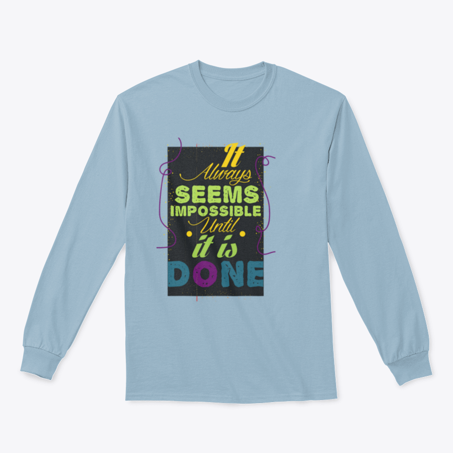 A cozy sweatshirt featuring the inspirational quote 'It Seems Impossible Until It's Done' in stylish typography, perfect for motivation.