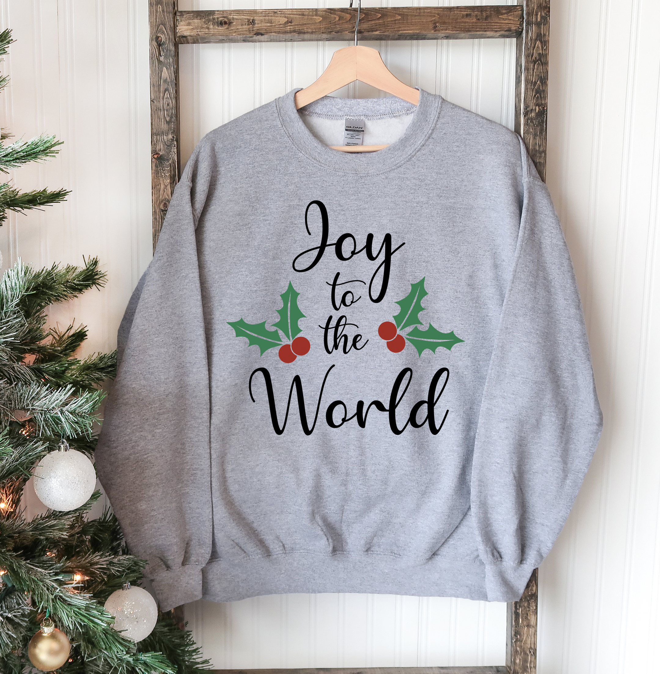 Joy To The World Christmas Sweatshirt featuring a crew neck design, soft fabric, and festive print, perfect for holiday celebrations.