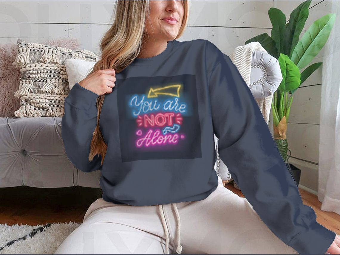 A vibrant sweatshirt featuring neon lettering that reads 'You're Not Alone', showcasing a classic fit and comfortable fabric.