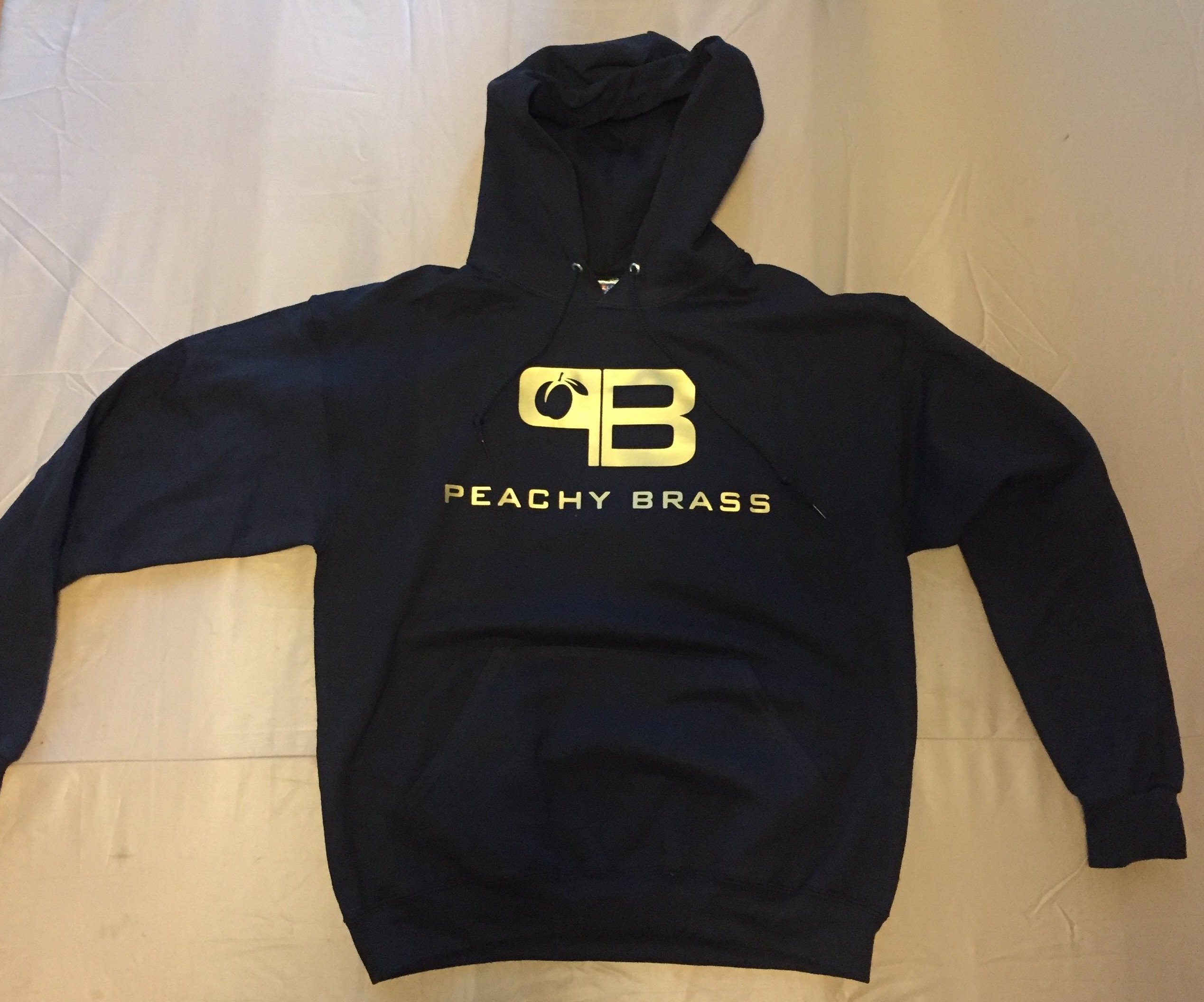 Peachy Brass Gold Hoodie featuring a stylish black color with gold logo and text, showcasing its comfortable design and quality craftsmanship.