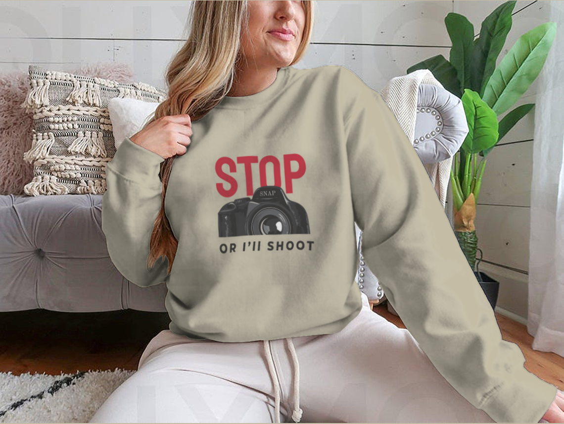 A stylish t-shirt featuring a camera illustration and a catchy slogan, made from 100% cotton for comfort.