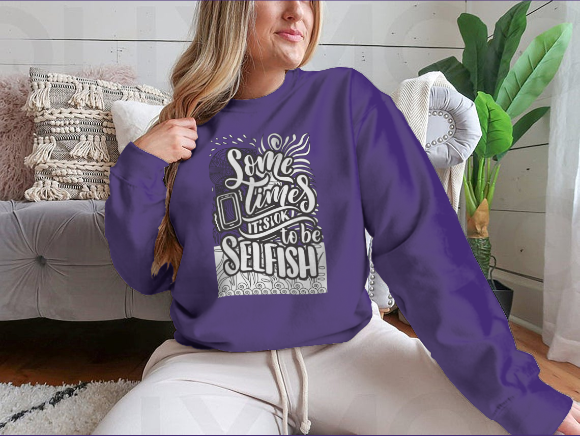 A cozy sweatshirt featuring the inspirational phrase 'Sometimes It's Okay To Be Selfish' in stylish typography, perfect for casual wear.