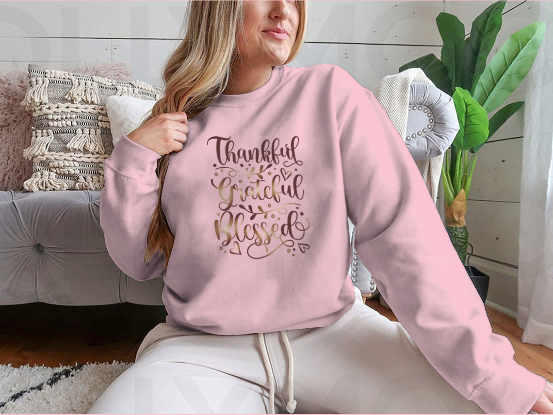 A stylish t-shirt featuring the inspirational quote 'Thankful Grateful Blessed' in a motivational design, perfect for casual wear.