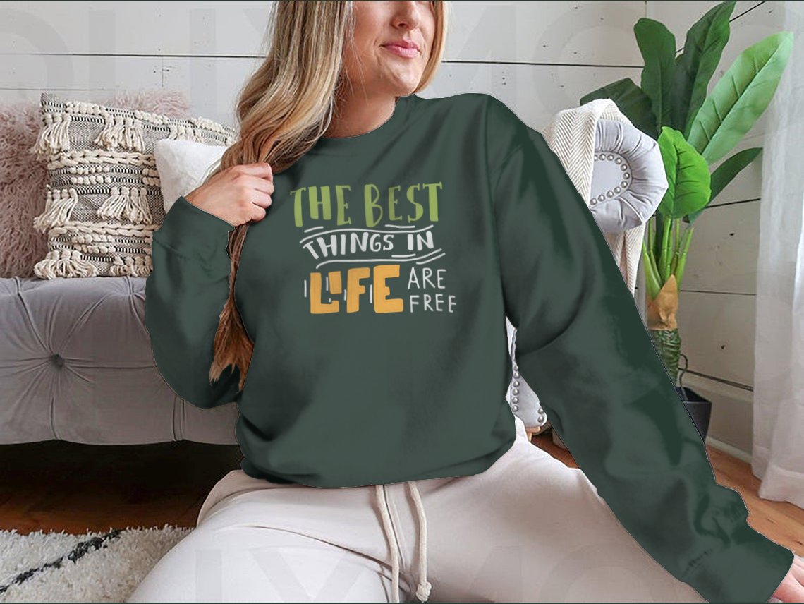 A stylish cotton shirt featuring the motivational quote 'The Best Things In Life Are Free' in elegant hand lettering design.