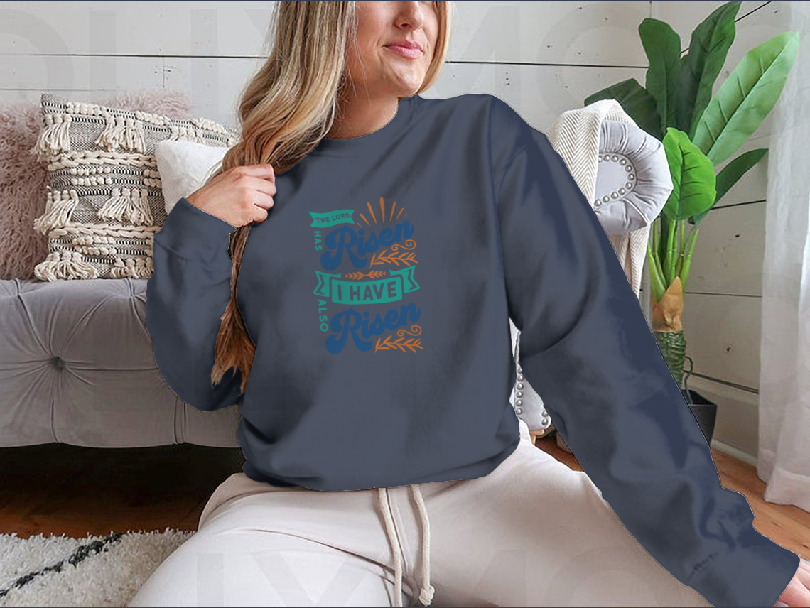A motivational apparel featuring the phrase 'The Lord Has Risen I Have Also Risen' in a stylish design, made from a comfortable cotton/polyester blend.