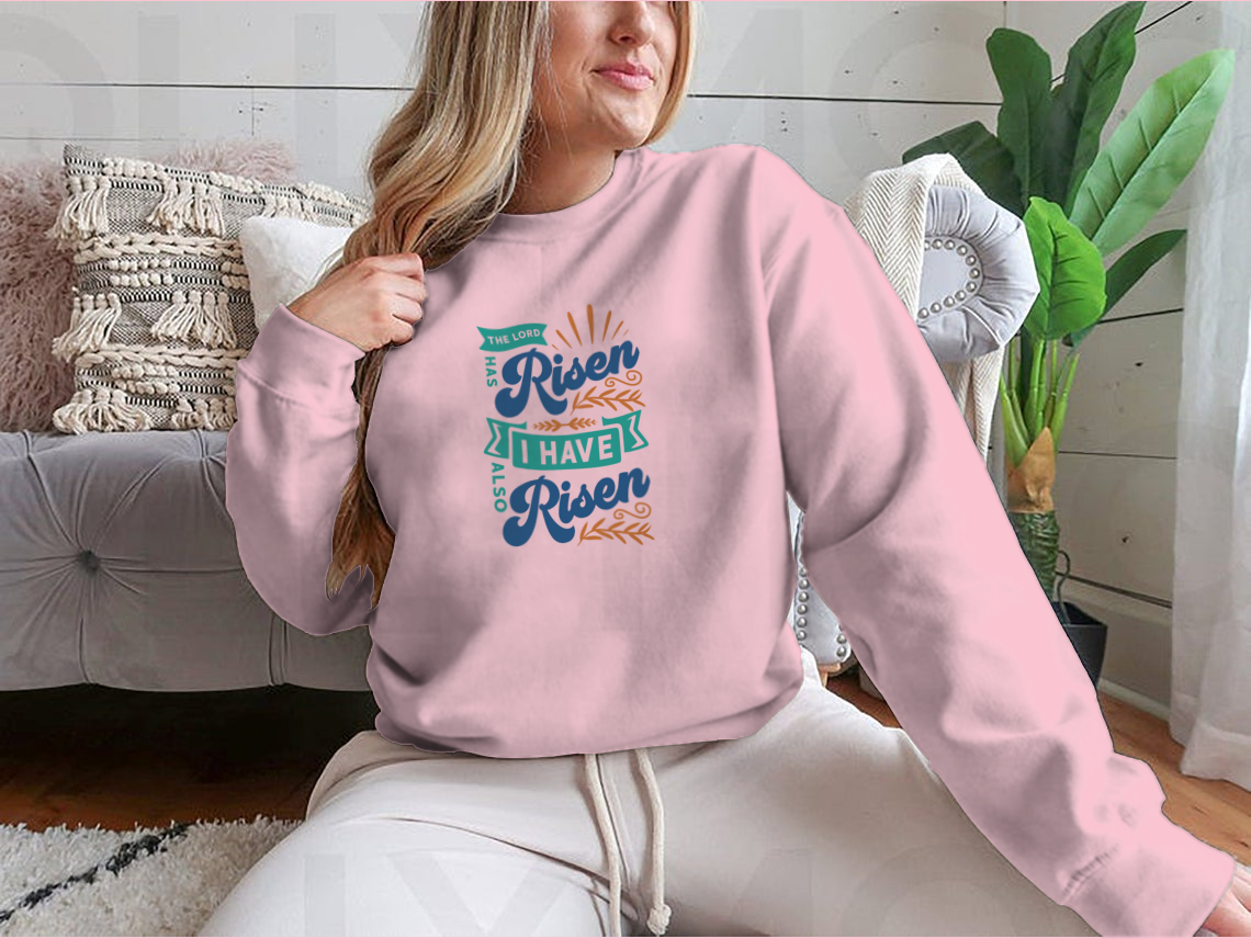 A motivational apparel featuring the phrase 'The Lord Has Risen I Have Also Risen' in a stylish design, made from a comfortable cotton/polyester blend.