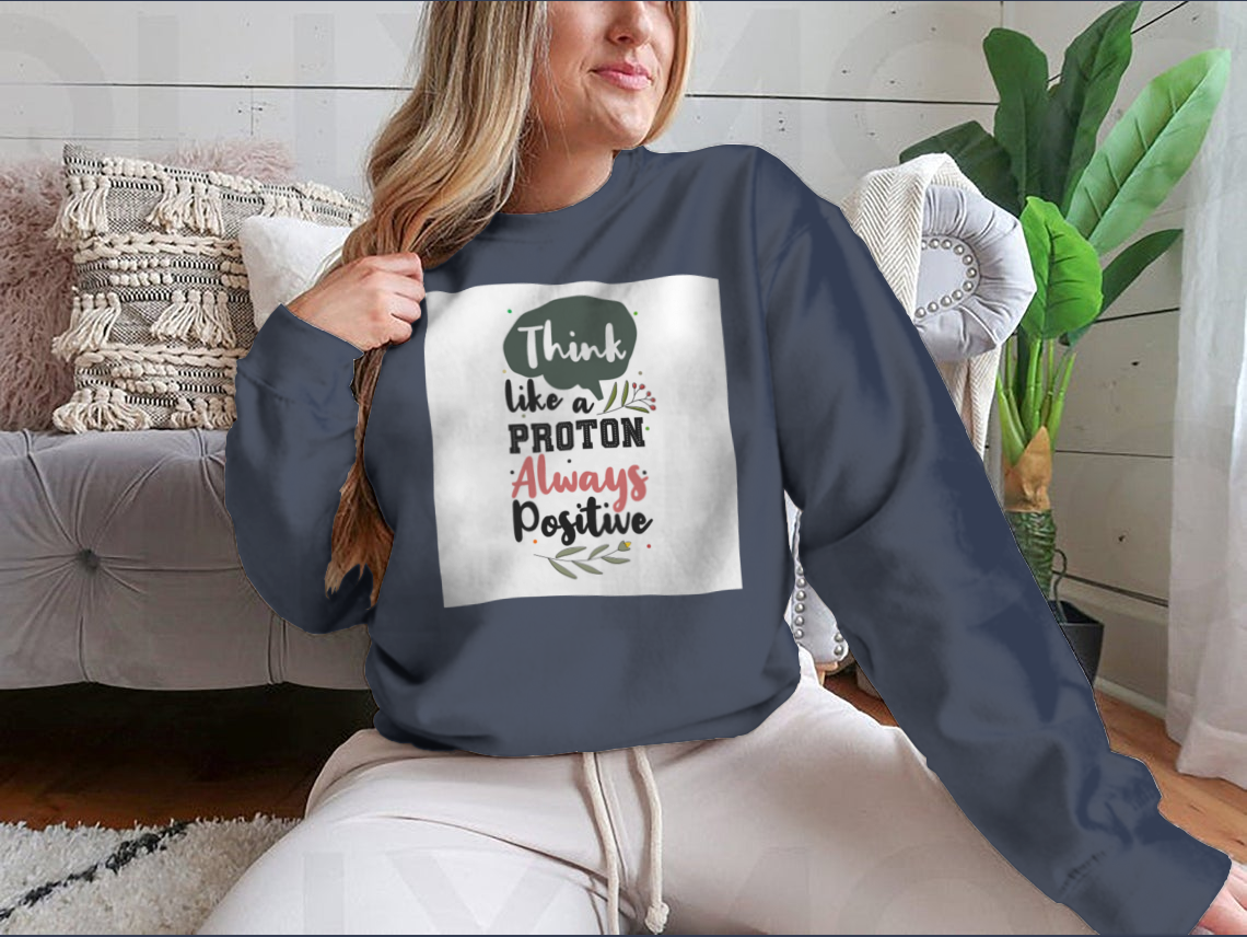 A premium motivational quote shirt featuring the phrase 'Think Like A Proton Always Positive' in a stylish design, made from soft cotton fabric.