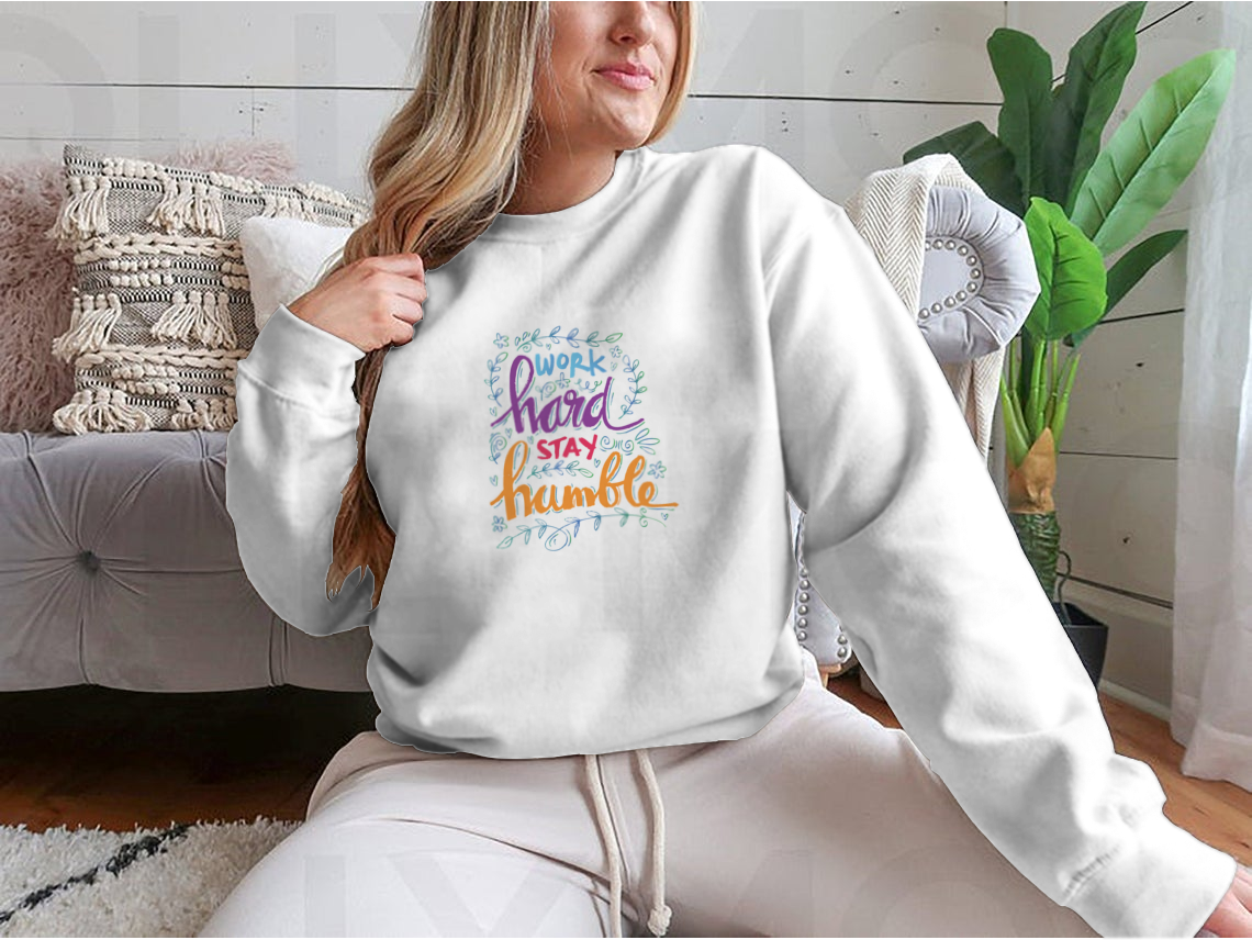 A cozy sweatshirt featuring the inspirational quote 'Work Hard Stay Humble' in stylish typography, perfect for casual wear.