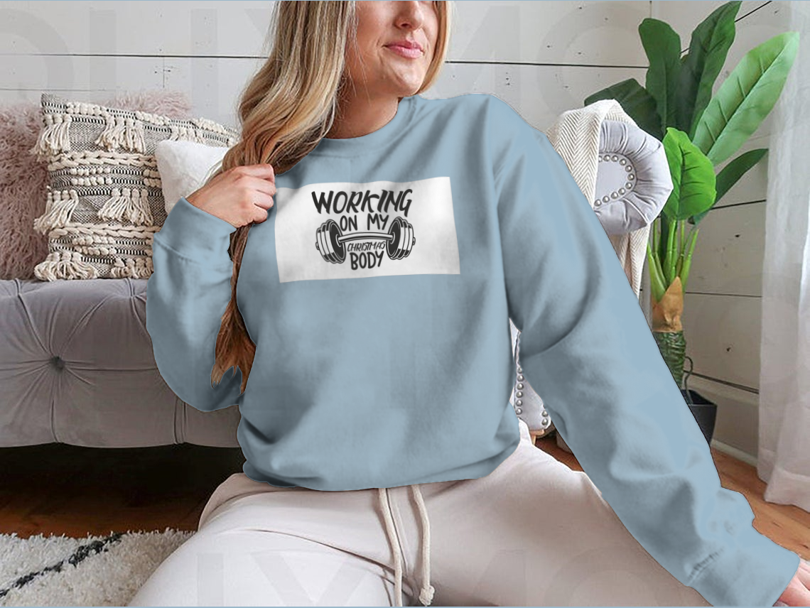 A cozy sweatshirt featuring the phrase 'Working On My Christmas Body', perfect for holiday celebrations.