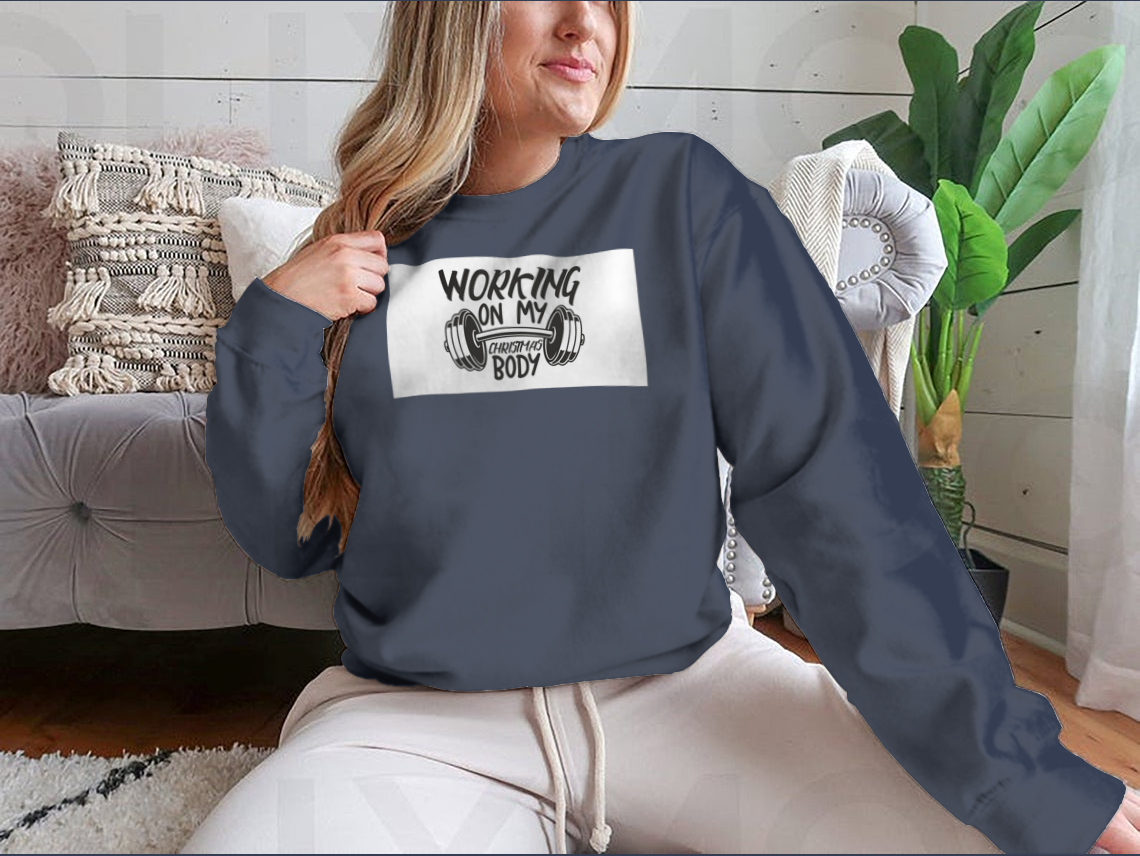 A cozy sweatshirt featuring the phrase 'Working On My Christmas Body', perfect for holiday celebrations.