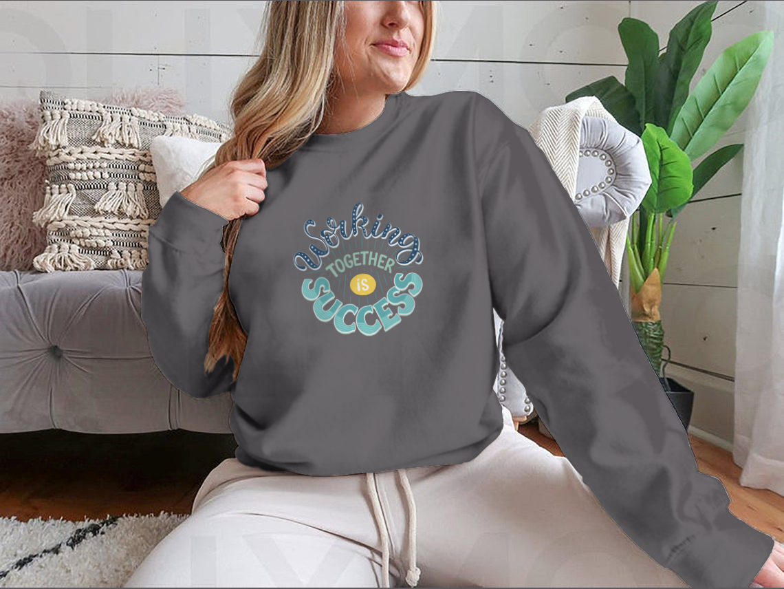 A cozy sweatshirt featuring the inspirational quote 'Working Together Is Success' in a stylish design, perfect for casual wear.