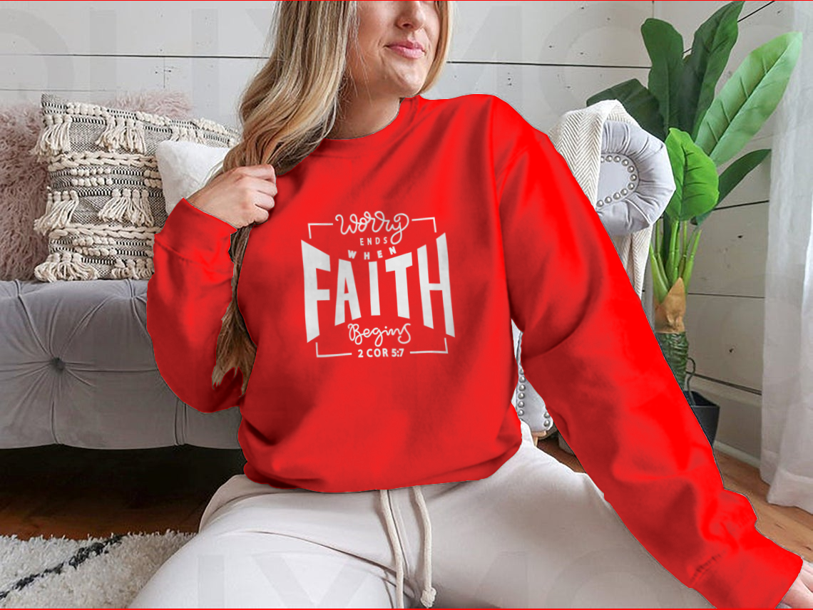 A cozy sweatshirt featuring the inspirational phrase 'Worry Ends When Faith Begins', showcasing a classic fit and soft fabric.