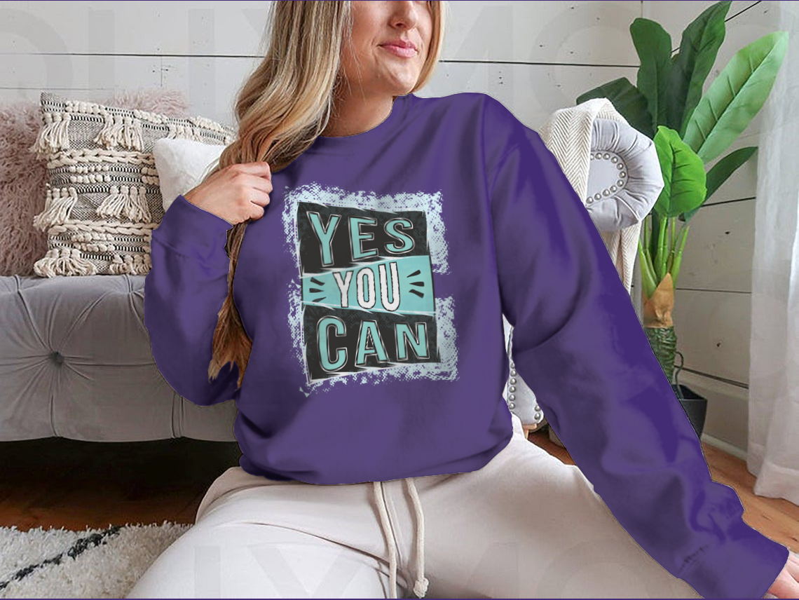 A cozy sweatshirt featuring the inspirational quote 'Yes You Can!' designed for comfort and style.