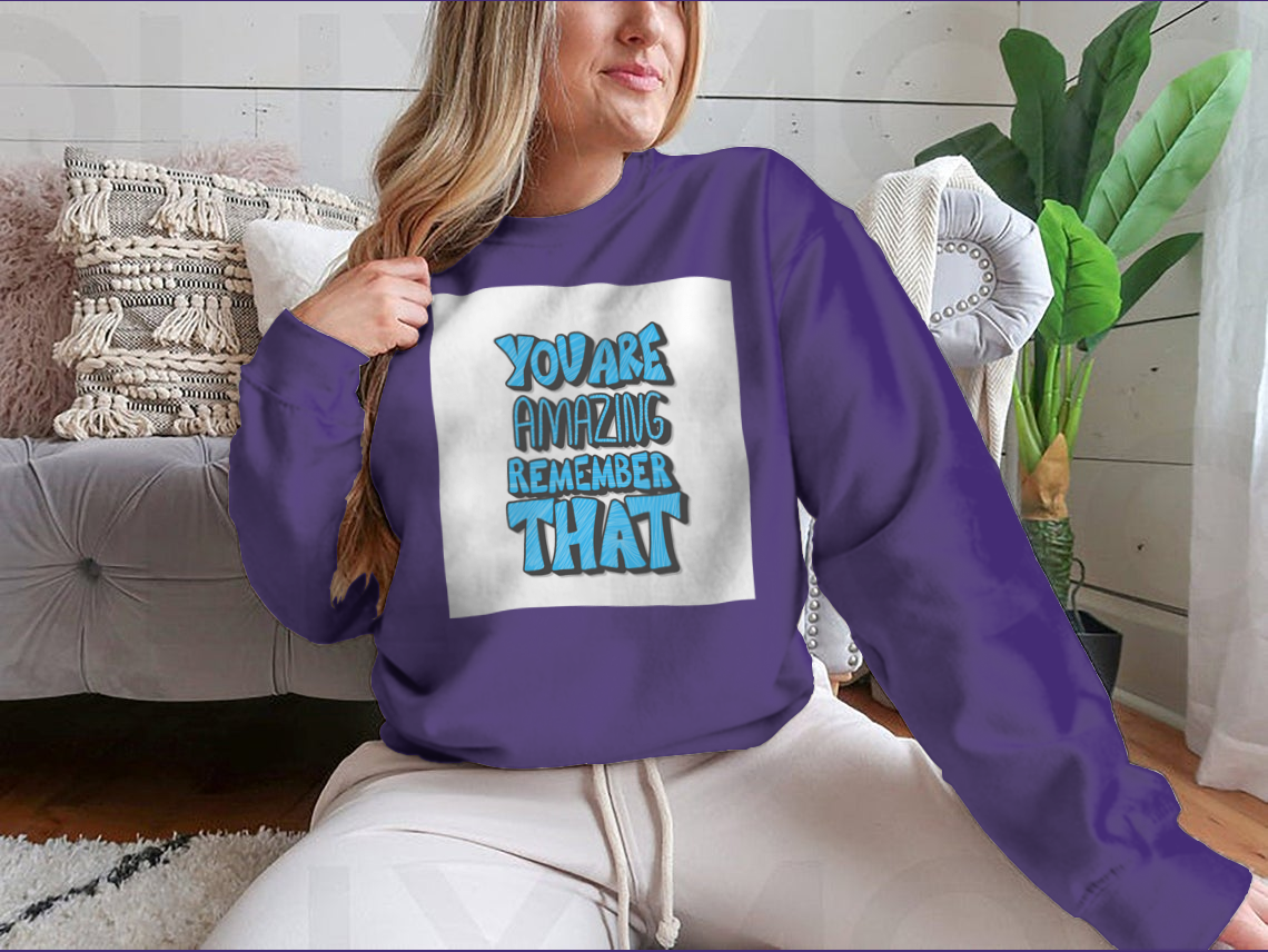 A cozy sweatshirt featuring the motivational quote 'You Are Amazing Remember That' in stylish typography, perfect for casual wear.