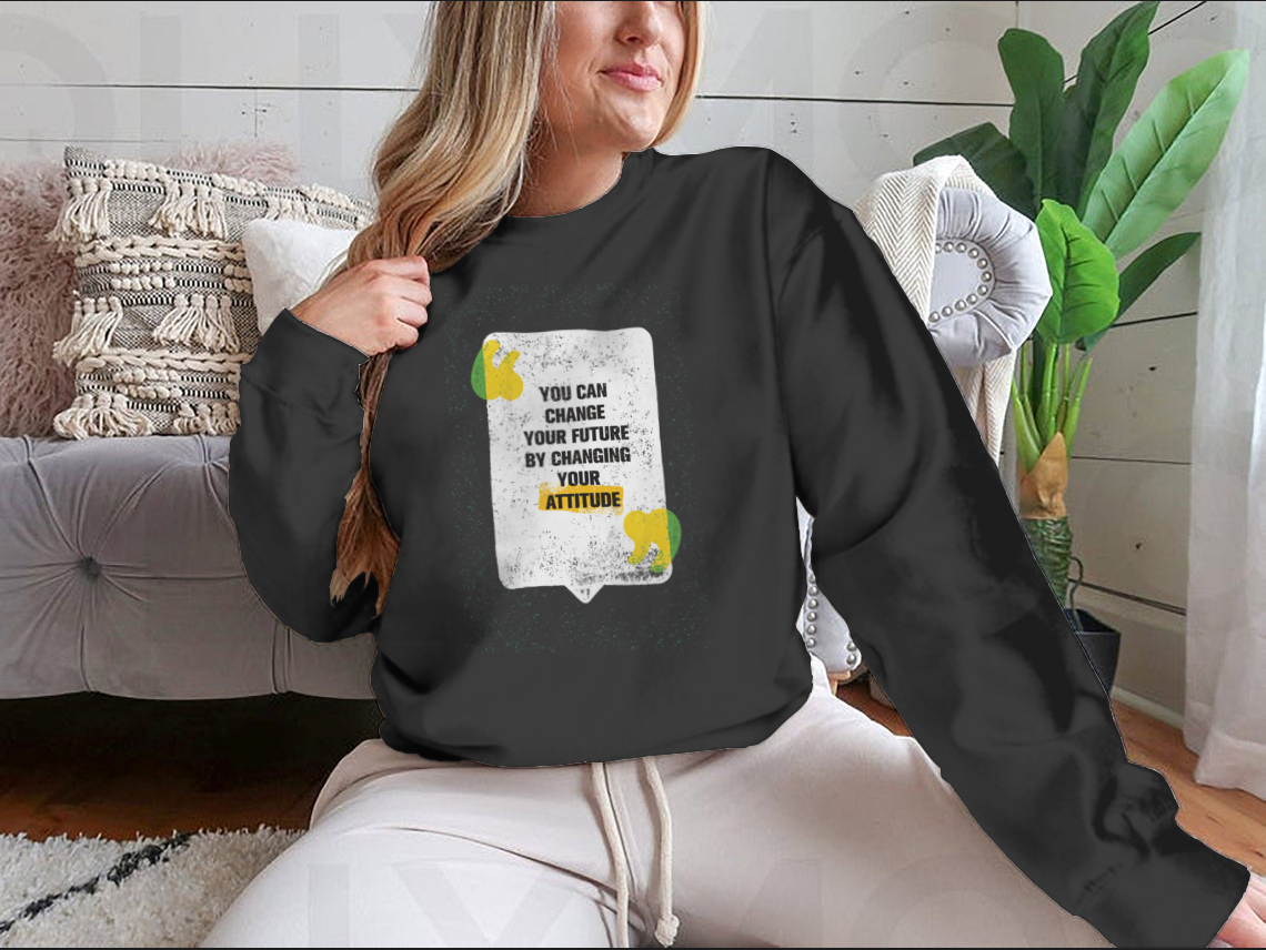 A modern t-shirt featuring the motivational phrase 'You Can Change Your Future By Changing Your Attitude' in a stylish design.