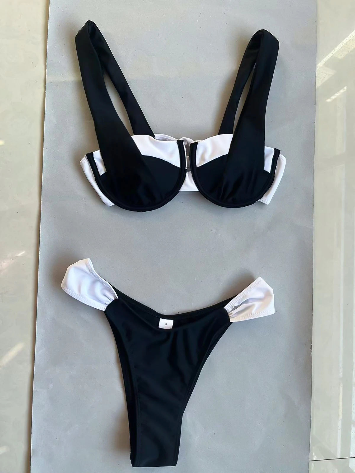Stylish Beatz two piece swimsuit in black, featuring a trendy patchwork design and wire-free support, perfect for summer beach outings.
