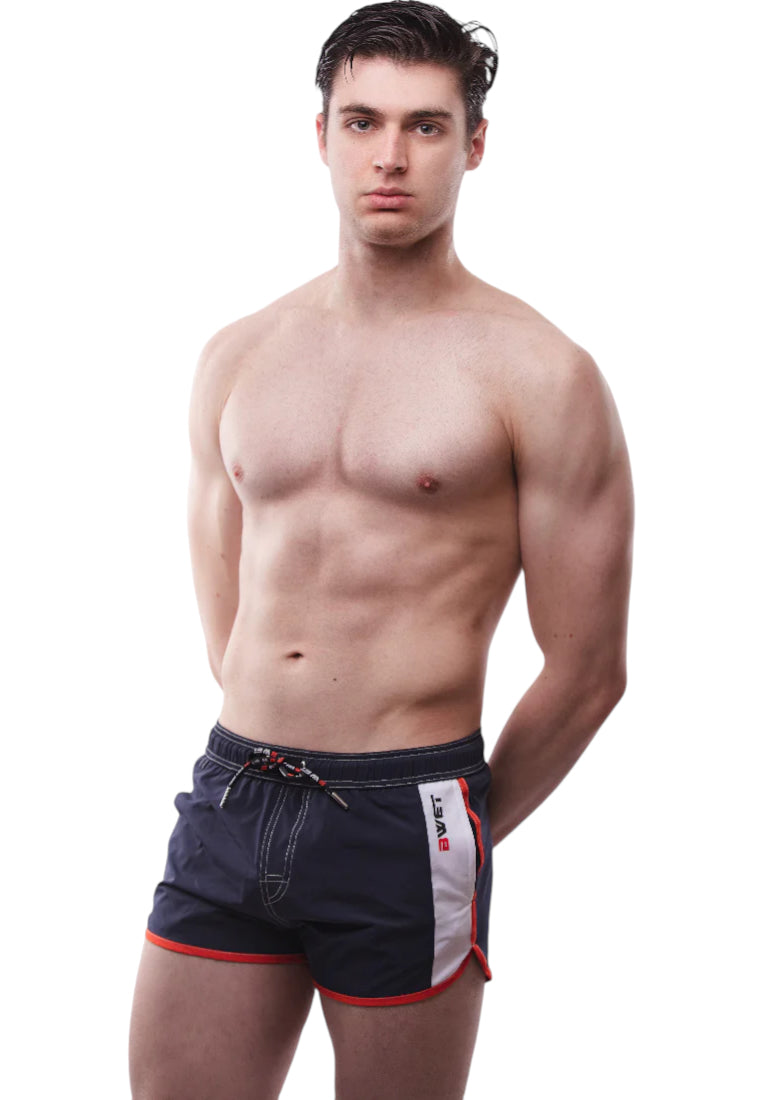 Trendy La Barceloneta Beach Shorts featuring an elastic waistband, adjustable drawstrings, and side pockets, perfect for summer beach activities.