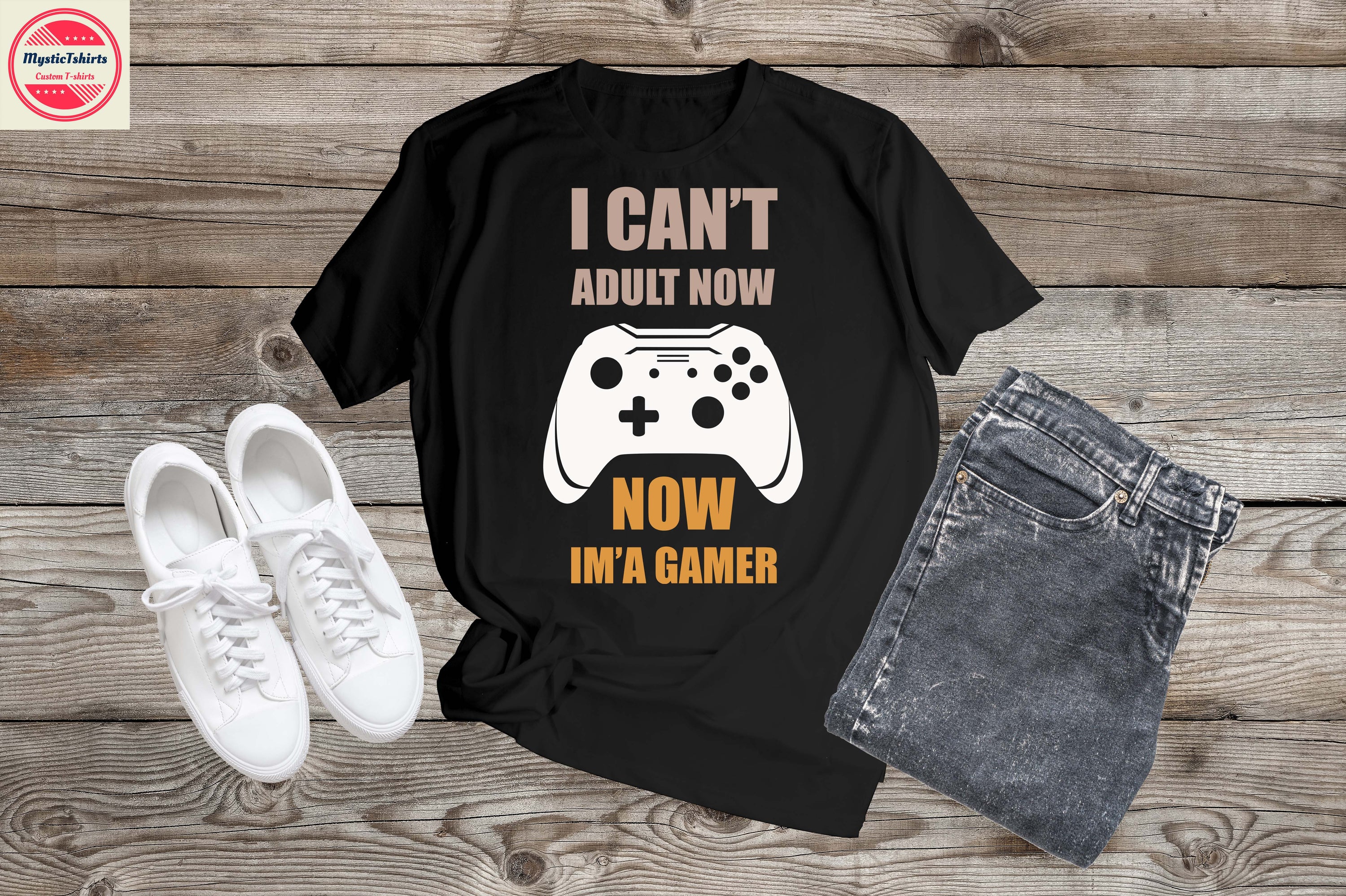 Custom made shirt featuring the phrase 'I CAN'T ADULT NOW, NOW IM'A GAMER' in vibrant colors on a high-quality fabric.