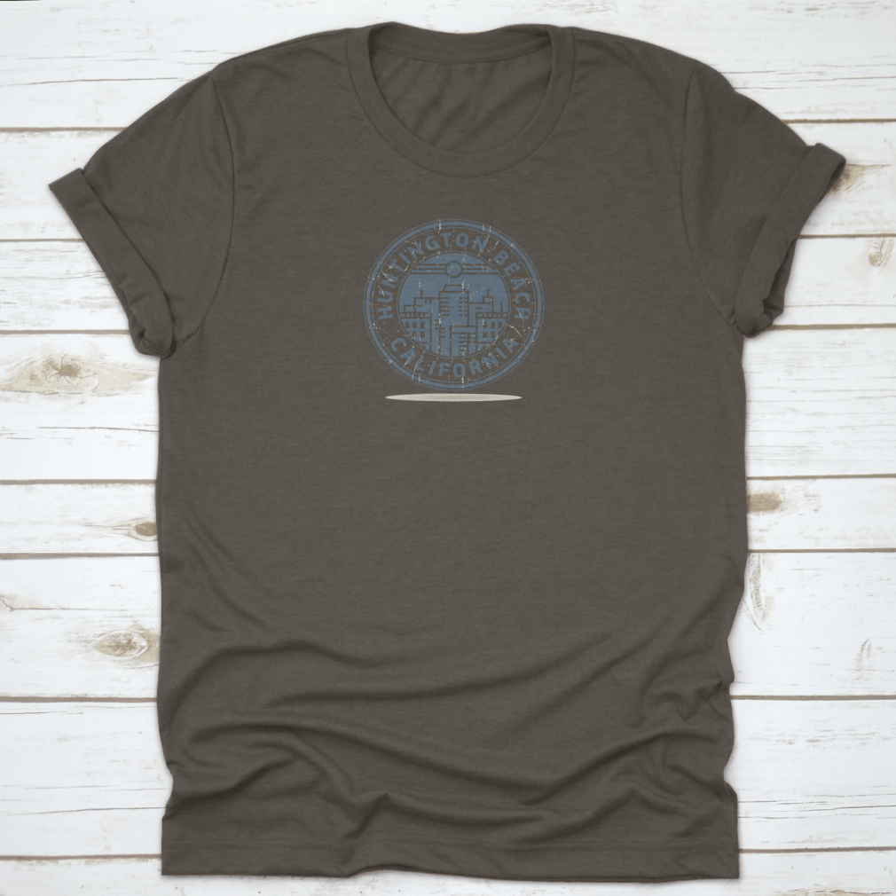 A stylish t-shirt featuring a stamp design of Huntington Beach, California, showcasing vibrant colors and a comfortable fit.