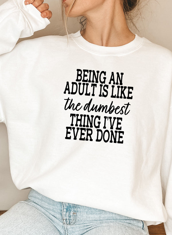 Cozy sweatshirt featuring the phrase 'Adulting Is The Dumbest Thing I've Ever Done', made from soft cotton/poly fleece blend.