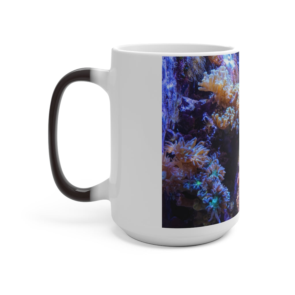A white ceramic color changing mug displaying vibrant colors when filled with hot liquid, featuring a C-handle and rounded corners.