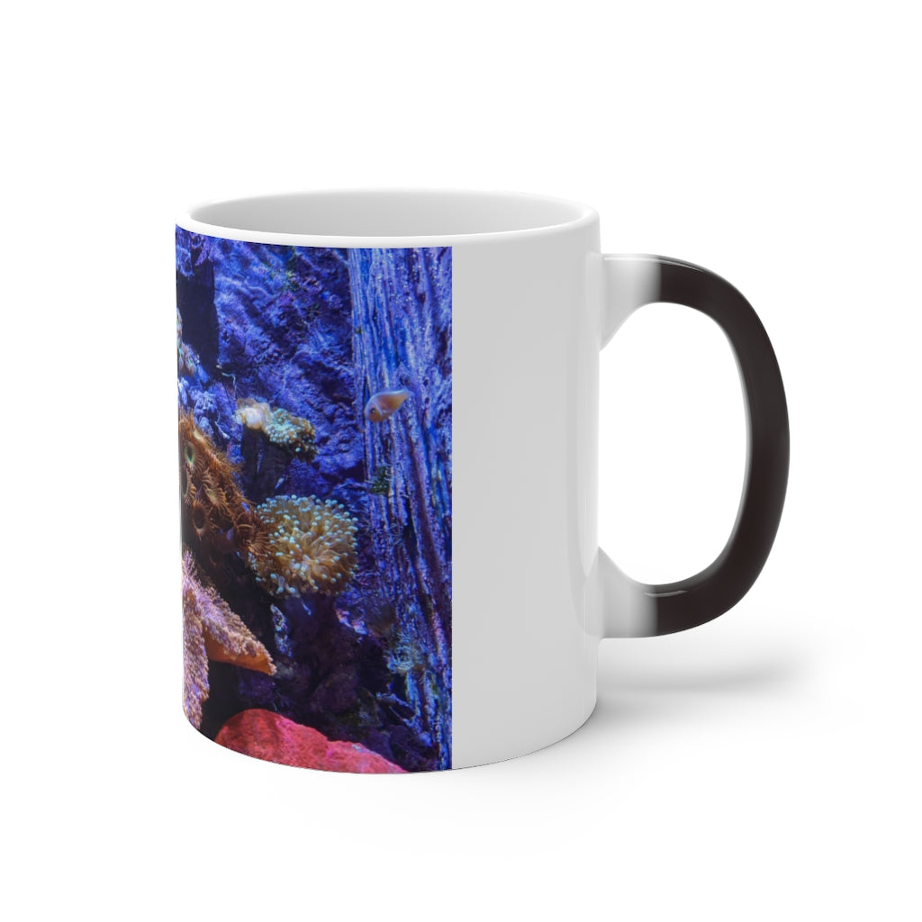 A white ceramic color changing mug displaying vibrant colors when filled with hot liquid, featuring a C-handle and rounded corners.