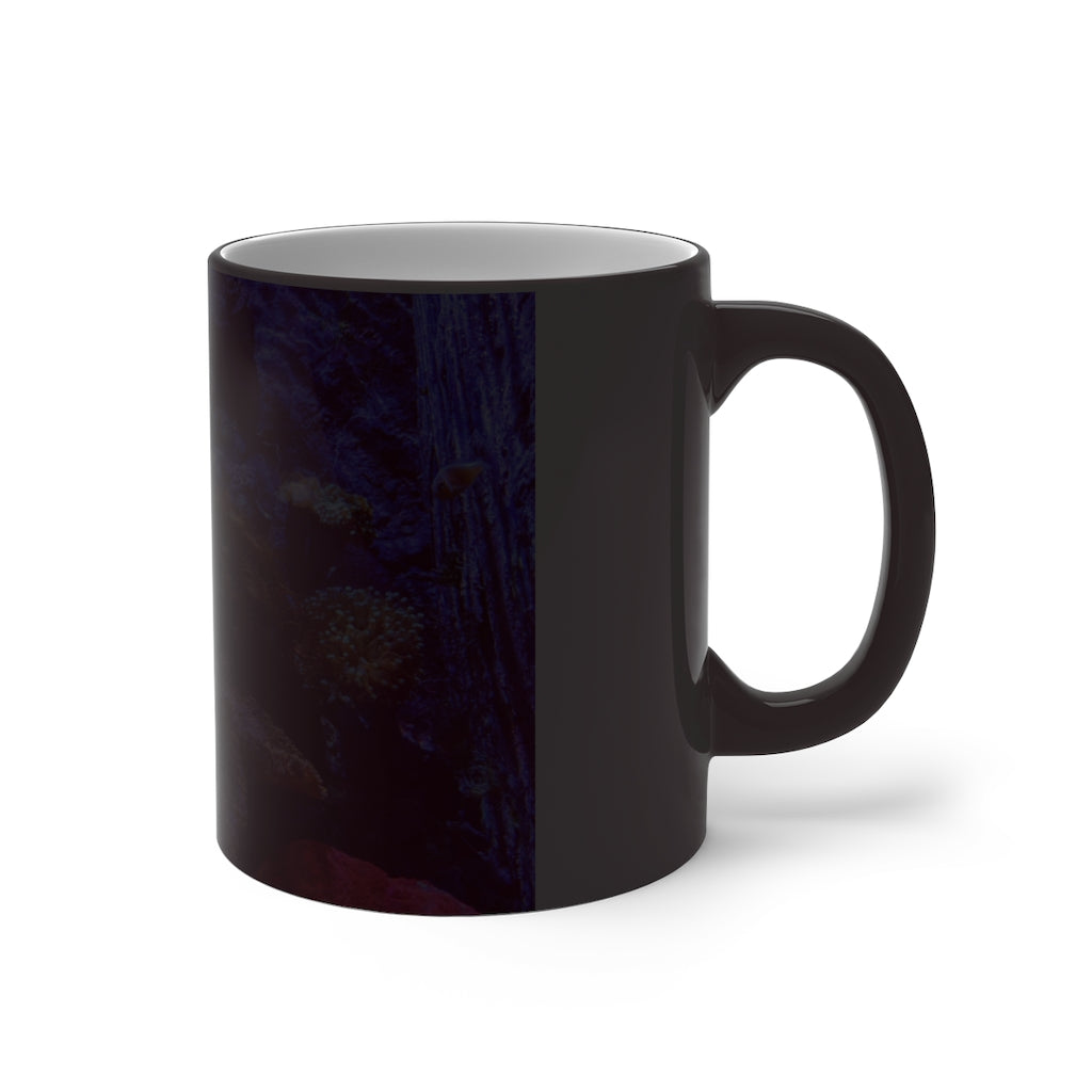 A white ceramic color changing mug displaying vibrant colors when filled with hot liquid, featuring a C-handle and rounded corners.