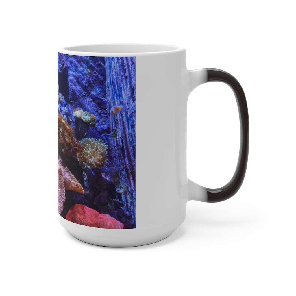 A white ceramic color changing mug displaying vibrant colors when filled with hot liquid, featuring a C-handle and rounded corners.