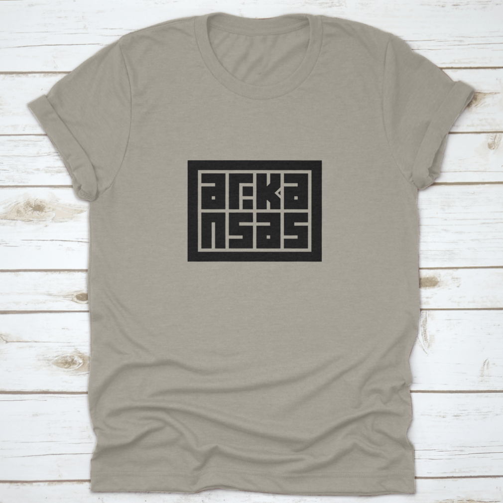 Arkansas Calligraphy Logo in decorative block code style typography on a cotton shirt, showcasing unique design and quality fabric.