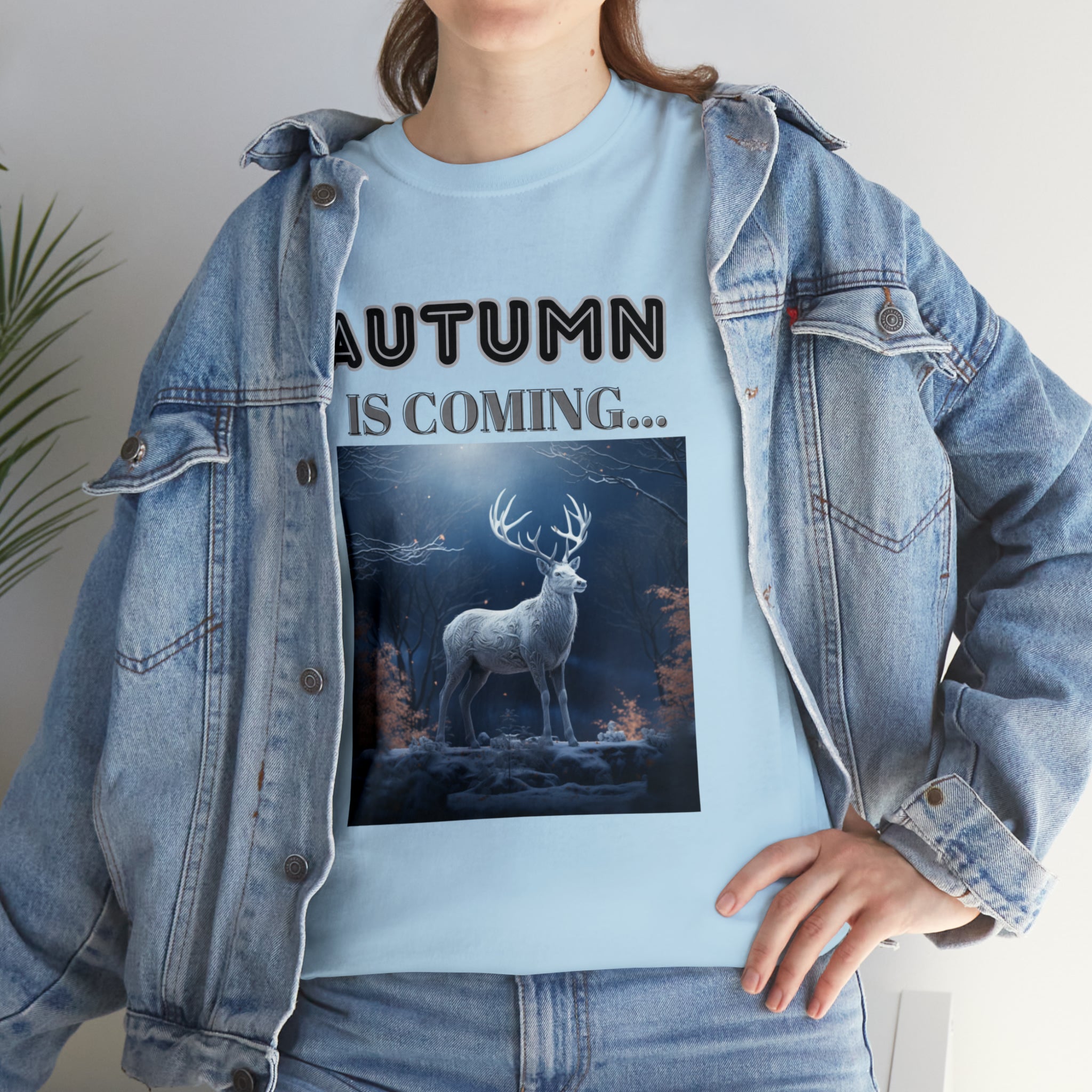 A stylish Fall Vibes T-shirt featuring a serene deer drinking from a brook surrounded by colorful autumn leaves.