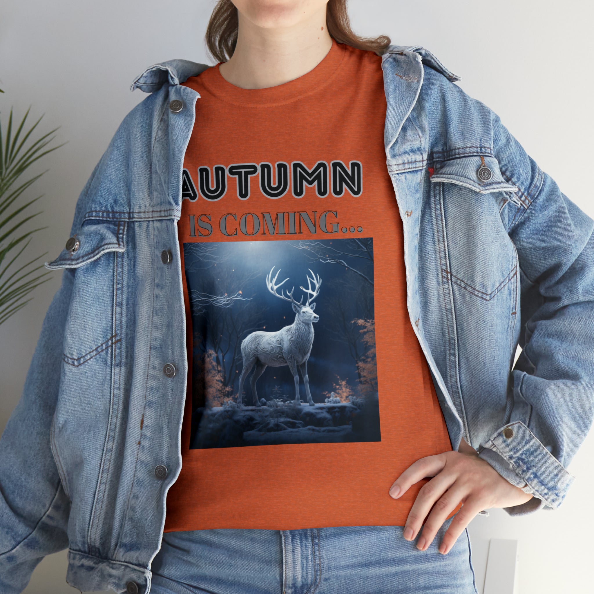 A stylish Fall Vibes T-shirt featuring a serene deer drinking from a brook surrounded by colorful autumn leaves.